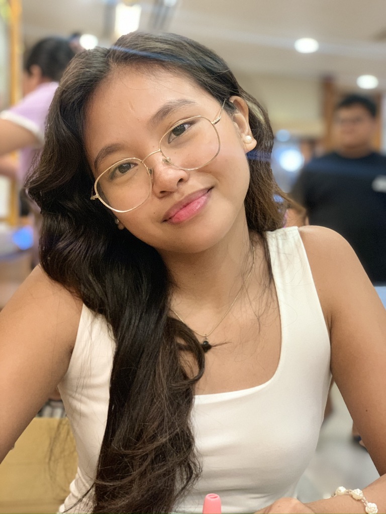 Yolyn smiling softly in a warm-lit room
